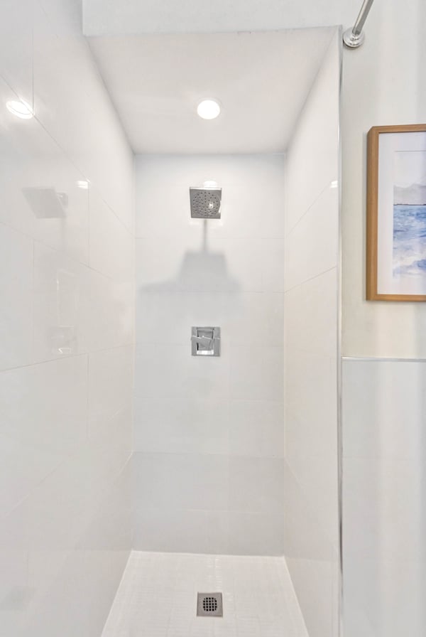 Sleek all-white walk-in shower