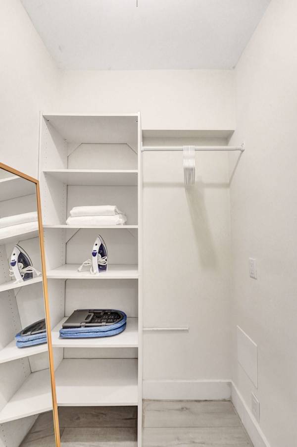Bright walk-in closet with open shelving