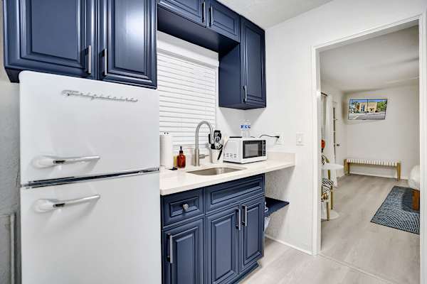 Navy kitchenette with retro fridge and bright counters