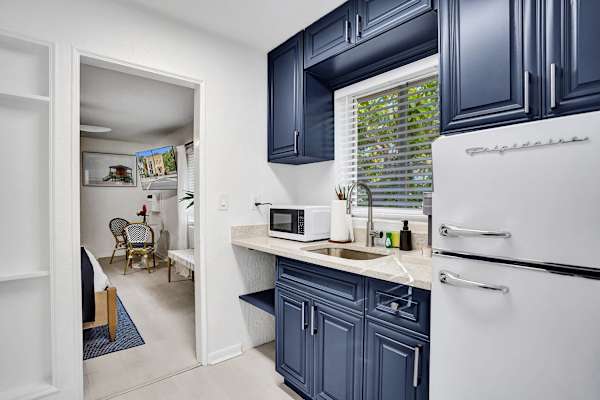 Kitchenette opening to bedroom sitting area beyond