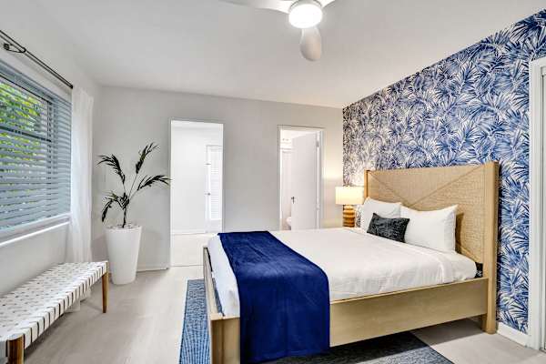 Airy king bedroom with bench seat and natural light