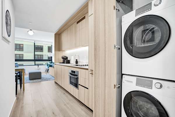 Sleek kitchen with modern appliances and in-unit washer and dryer for added convenience.