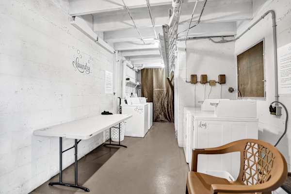 Shared laundry room with washers and folding table