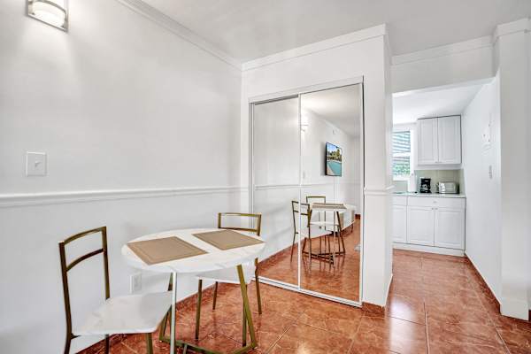 Bright dining nook with mirrored closet doors