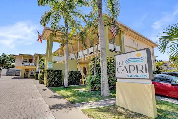 The Capri property entrance with palm trees