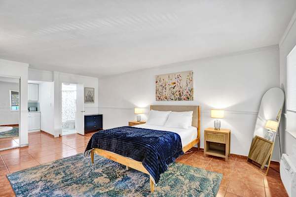 Bright studio bedroom with full-length mirror