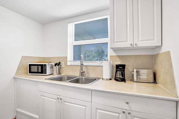 Kitchen counter with microwave, coffee maker and sink