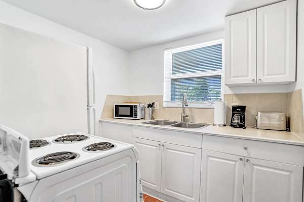 White kitchen with full appliances and counter space