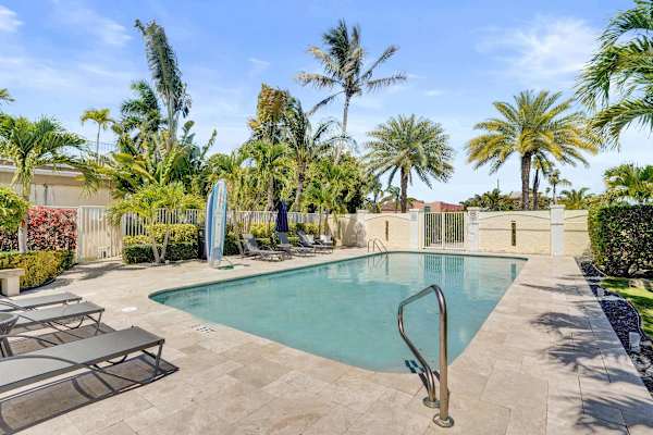 Tropical pool with palm trees and lounge chairs