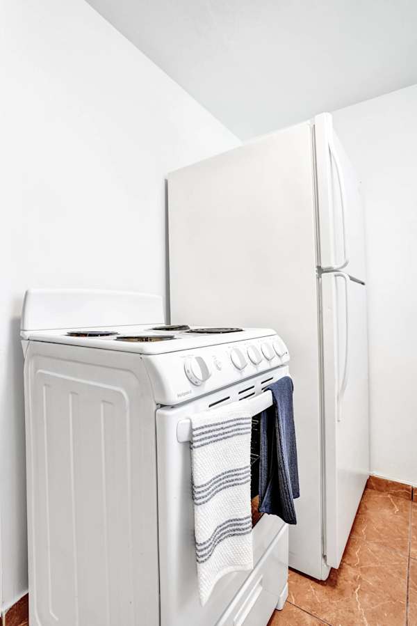 Stove and refrigerator in compact kitchen