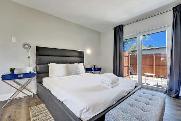 King bed with patio access and natural light