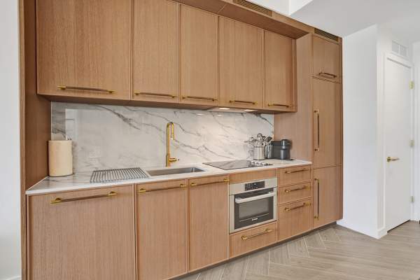 Designer kitchen with marble backsplash and gold fixtures