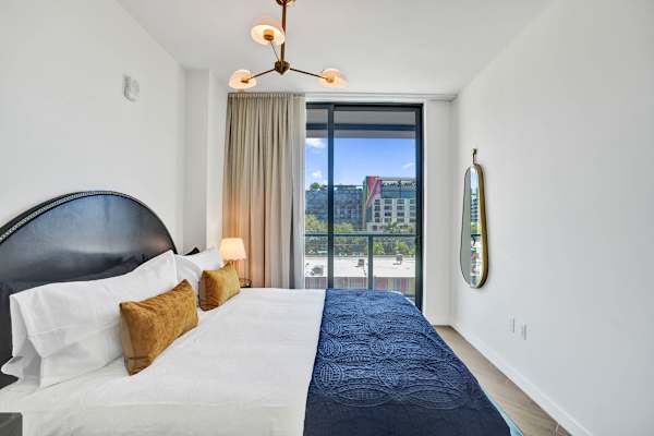 King bedroom with floor-to-ceiling balcony views