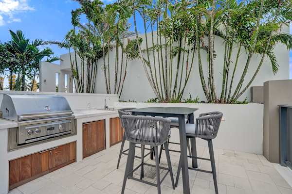 Outdoor kitchen with BBQ grill and bar