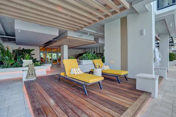 Sunny pool deck with cushioned chaise loungers