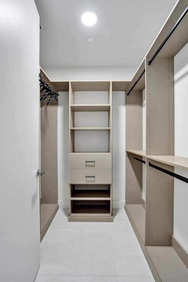 Spacious walk-in closet with custom shelving