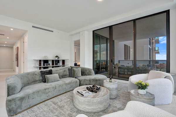Living room with balcony access and built-ins