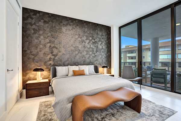 Master bedroom with balcony and accent wall