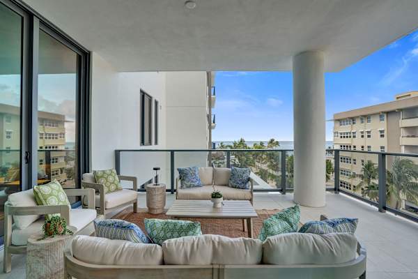 Large furnished balcony with coastal views