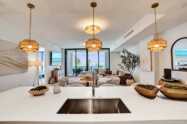 Kitchen sink with ocean-view living beyond