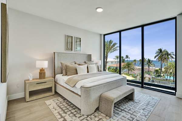 Primary king bedroom with ocean and palm view
