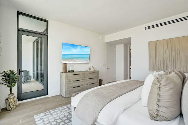 Bedroom with TV dresser and balcony access