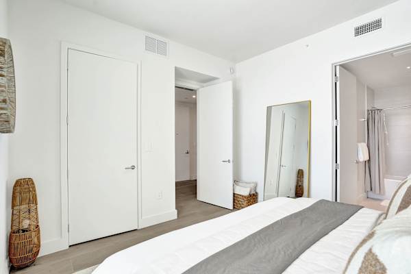 Third bedroom with closet and full-length mirror