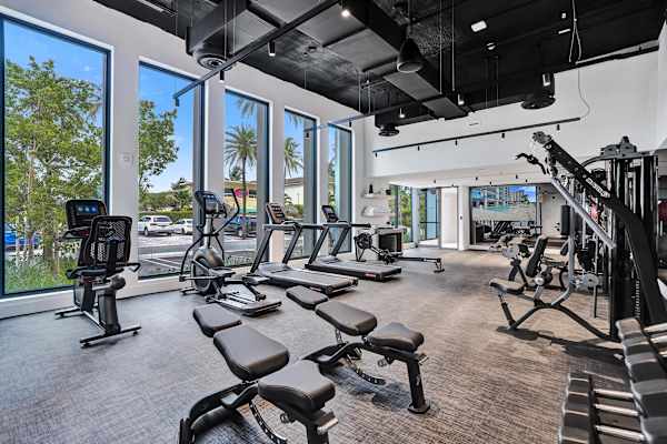 Fitness center with cardio machines and floor-to-ceiling windows