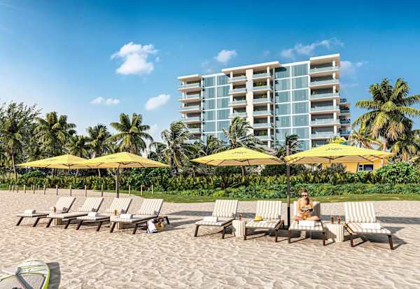 Beach loungers and umbrellas in front of building