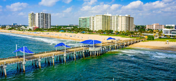 Pompano Beach pier stretching into blue ocean waters