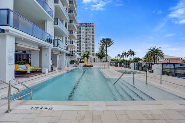 Outdoor pool with city and palm tree views