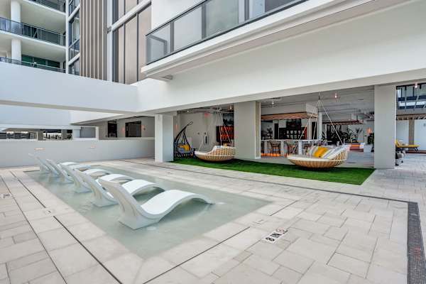 Poolside lounge chairs beside a shallow wading pool