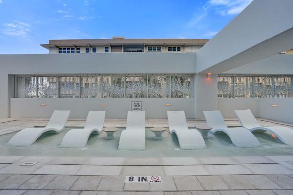 Poolside lounge chairs beside shallow wading pool