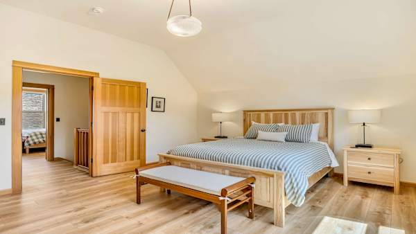 Spacious upstairs bedrooms provide a comfortable retreat for guests.