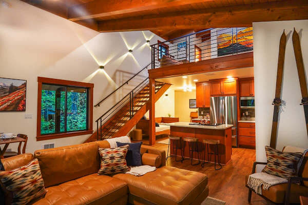 View from the living room towards the full kitchen with the stairs to the loft on the left. 