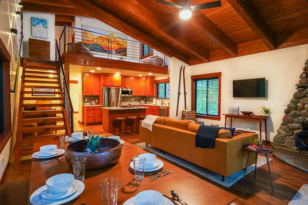 Looking over the dining room table towards the living room and kitchen.
