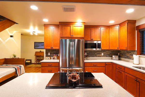 Full kitchen looking over the stove towards the fridge.