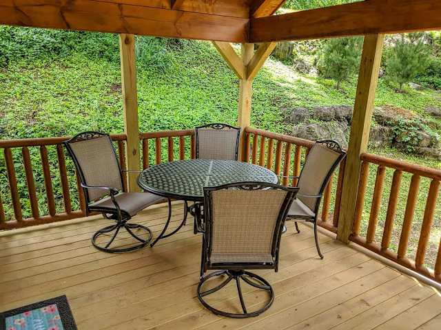 Enjoy dinner from your front deck dining patio featuring a charcoal grill.