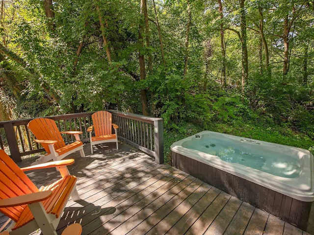 Private back deck with hot tub and seating.