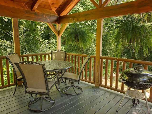 Front deck dining featuring a charcoal grill.