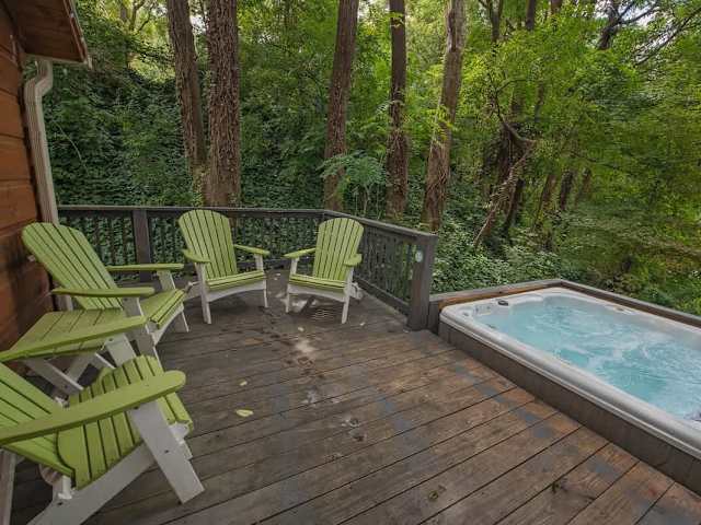 Back deck with private hot tub and outdoor seating.