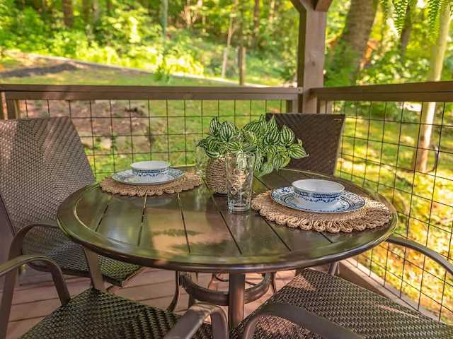 Front deck with a charcoal grill and dining