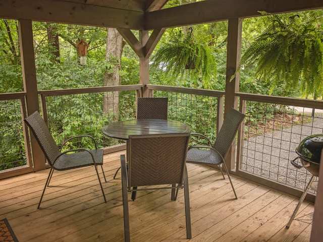 Covered front porch with charcoal grill and outdoor seating