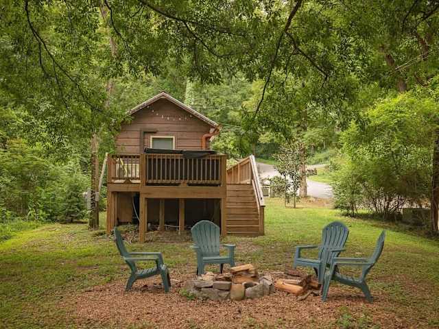 Private fire pit and seating off of back deck with private hot tub.