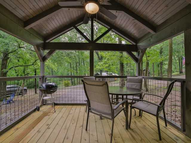 Covered front porch with barbecue grill and outdoor seating