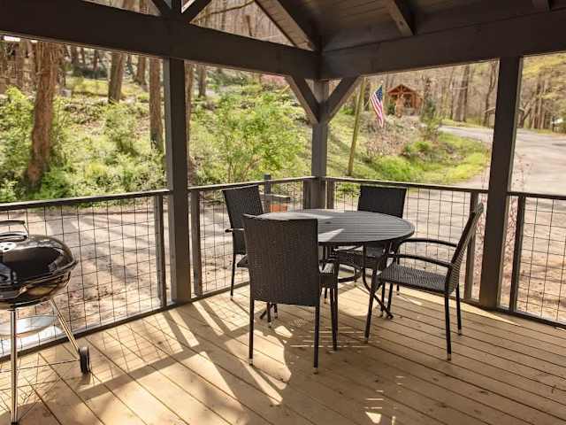Covered front porch with barbecue grill and outdoor seating