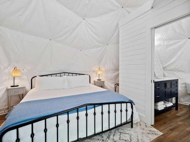 Restful queen bed with soft linens inside the dome, designed for cozy nights after lake or trail adventures.