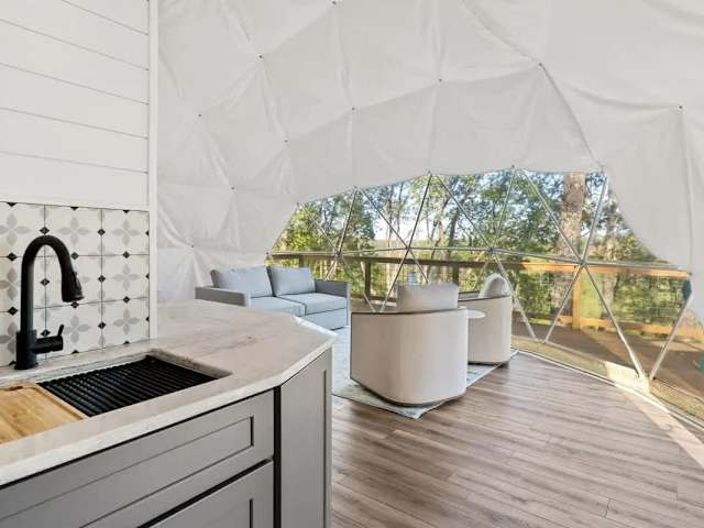 Bright kitchenette featuring sink, storage, and outdoor views, blending convenience with the natural surroundings.