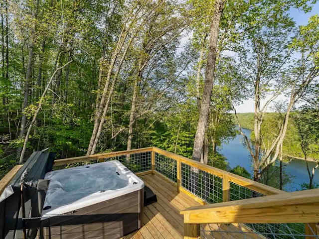 Relax in a private hot tub overlooking the trees and Center Hill Lake, perfect for unwinding year-round.