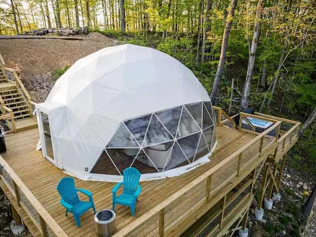The Burgess Falls Dome with private deck, hot tub, and seating, tucked into the trees above Center Hill Lake.
